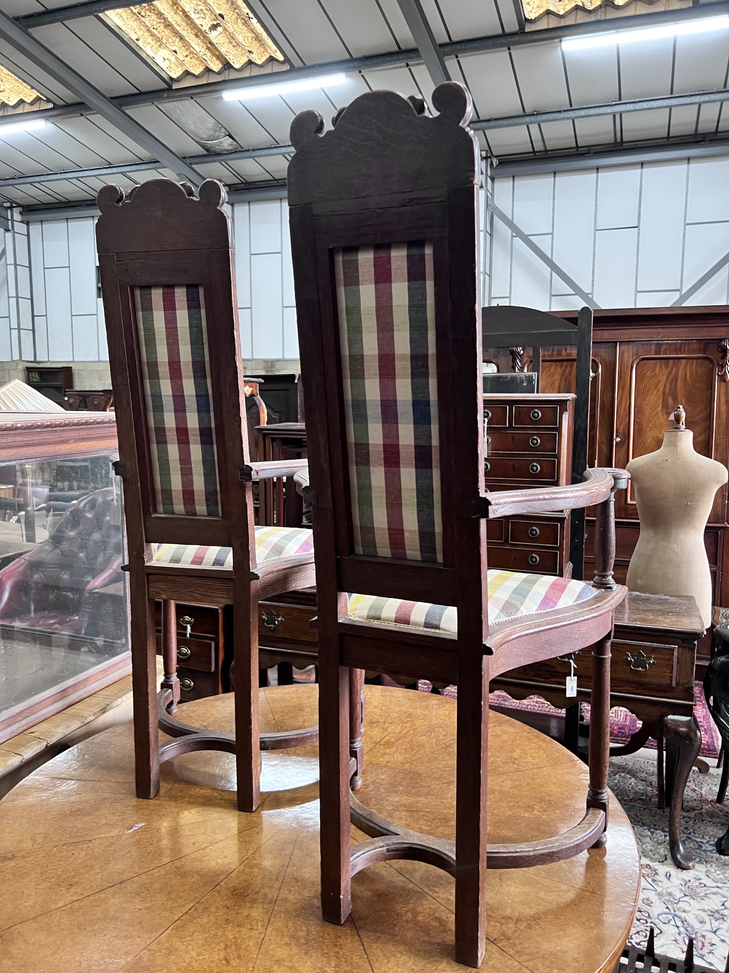 A set of four early 20th century French carved oak elbow chairs, width 59cm, depth 43cm, height 124cm